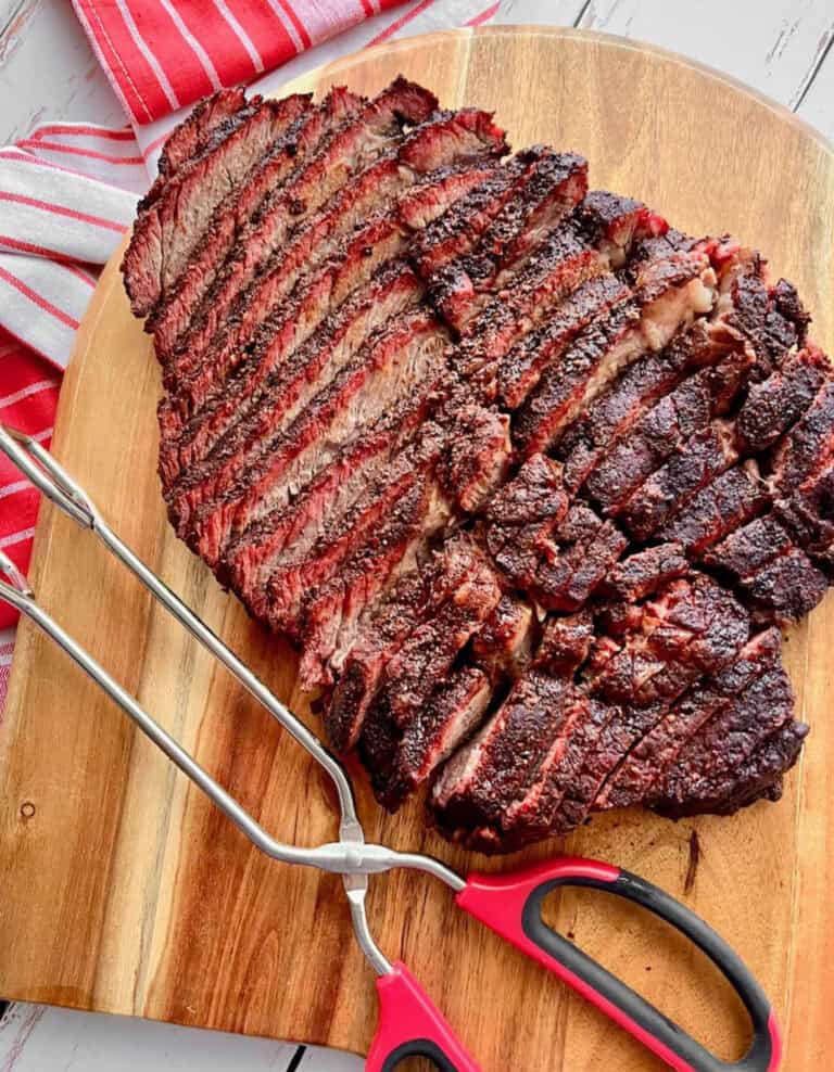 Smoked Chuck Roast on Cutting Board with Red Tongs