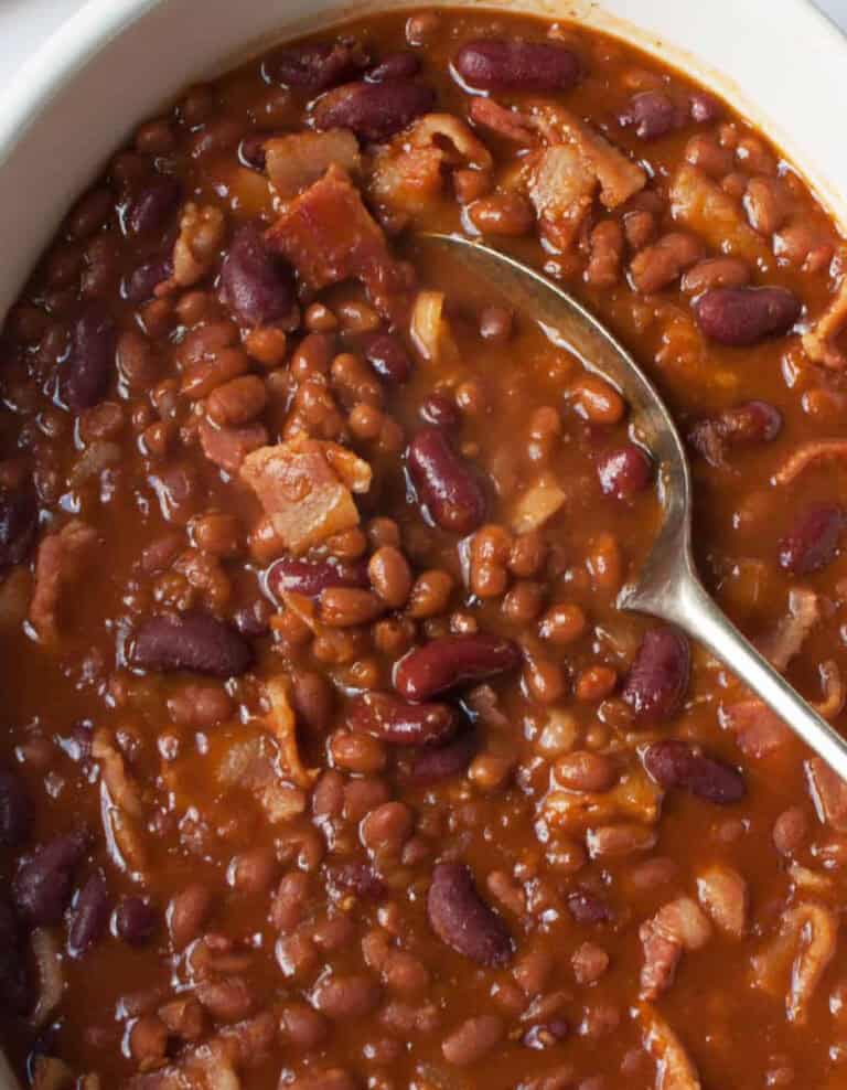 Dr. Pepper Baked Beans in White Serving Dish with Spoon