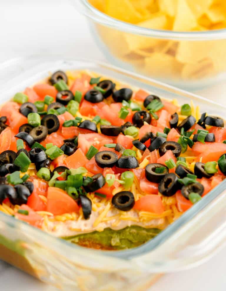 Closeup of 7 Layer Taco Dip with Corner Scooped Out