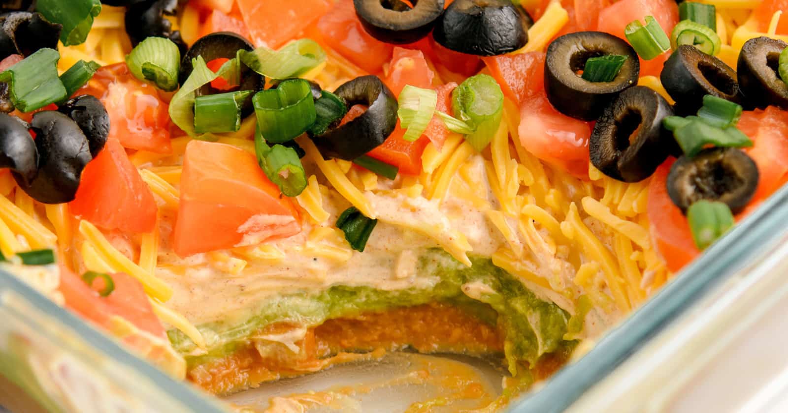 Closeup of 7 Layer Taco Dip with Corner Scooped Out