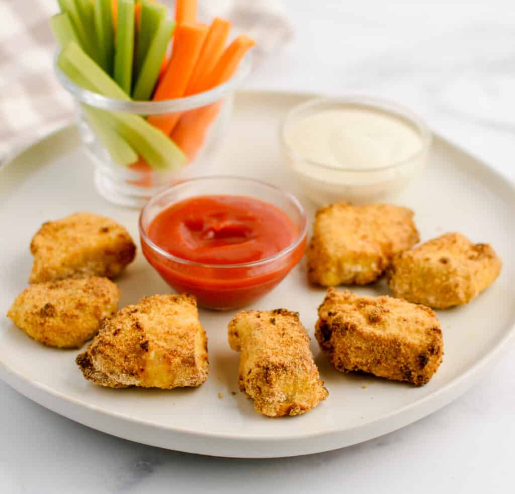 Chicken Nuggets on Plate with Sauces and Veggie Sticks