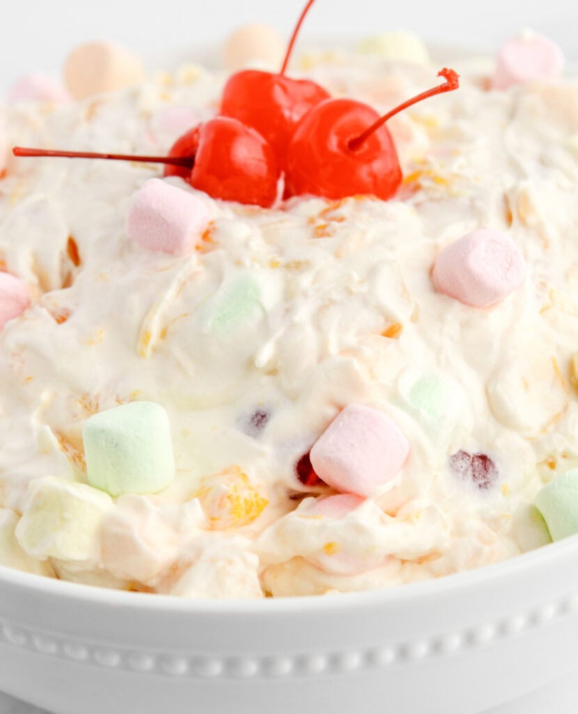 Ambrosia Salad in Bowl with Marshmallows and Cherries on Top