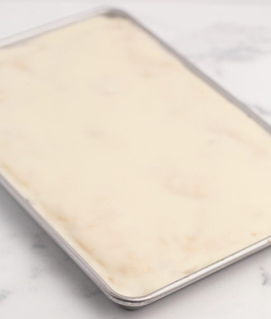 Apple Pie Bars on Baking Sheet with Frosting