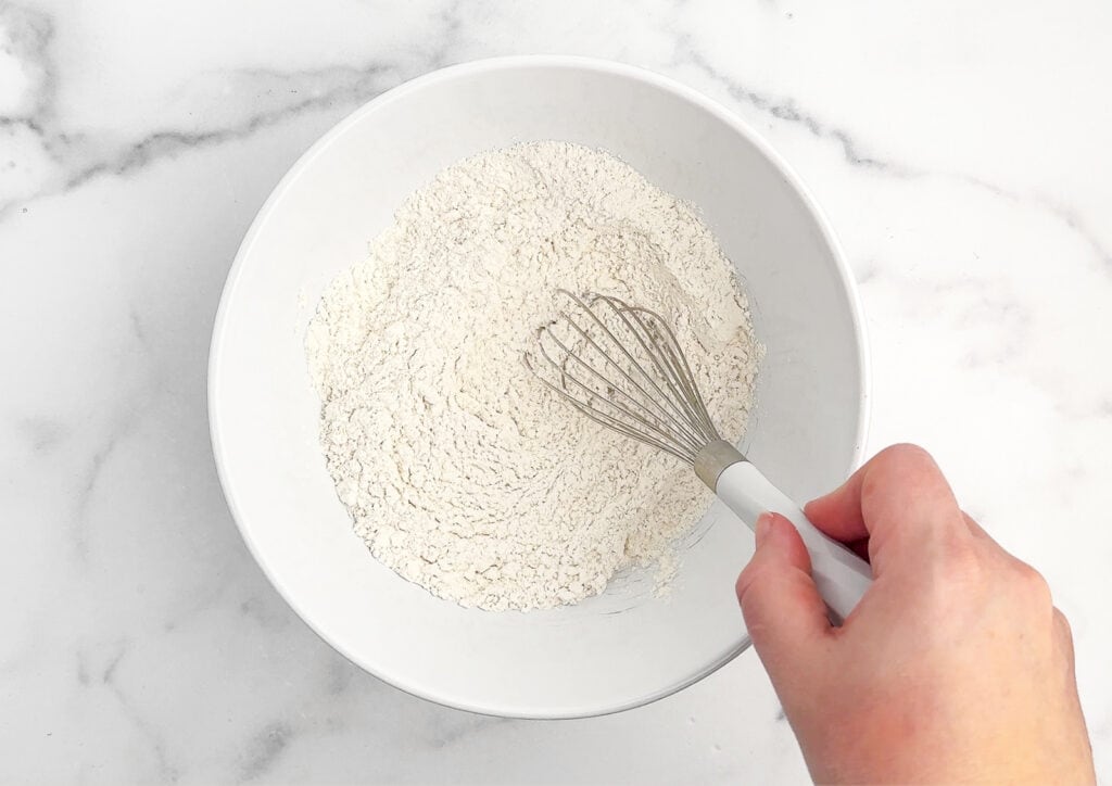 Mixing Dry Ingredients in White Bowl with Spoon