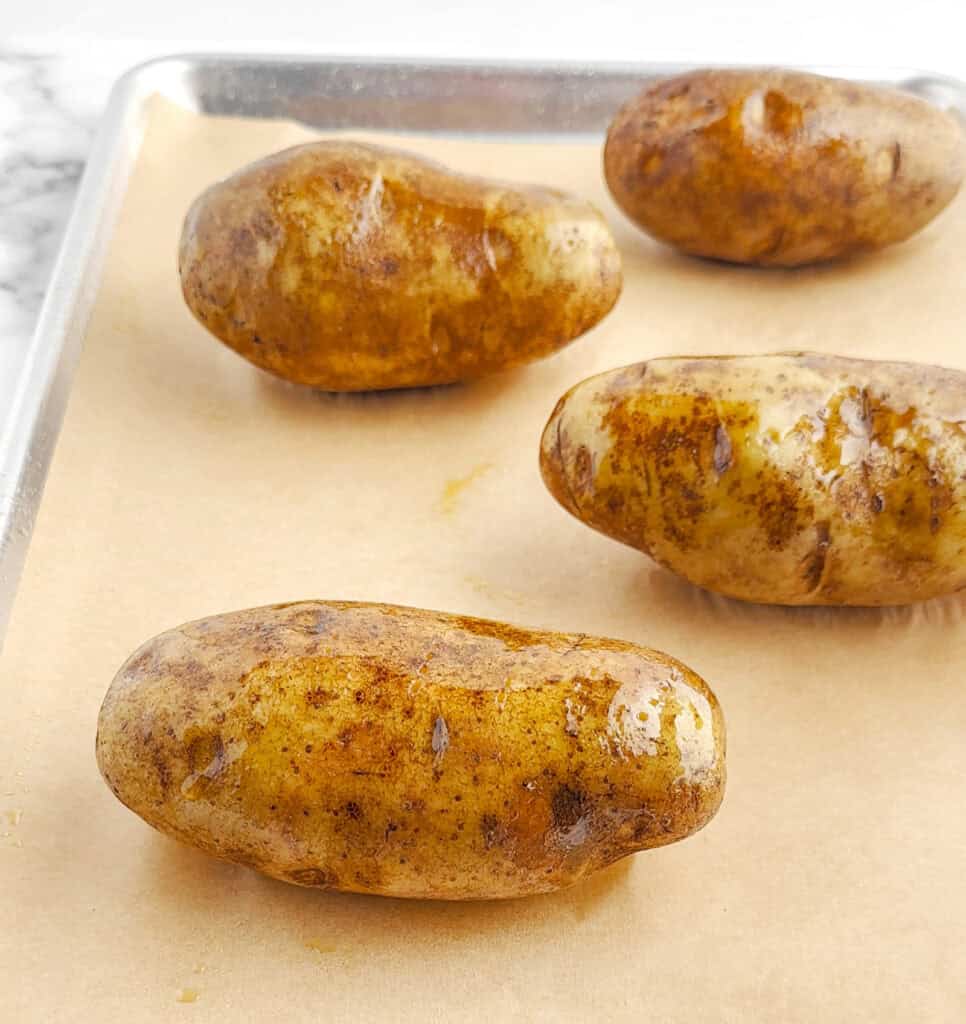 Oiled Potatoes on Baking Sheet with Parchment