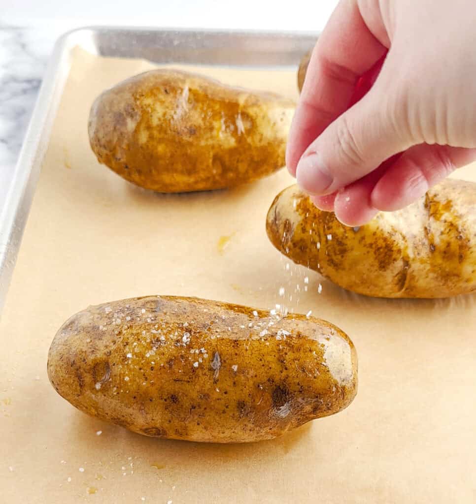 Salting Potatoes on Baking Sheet with Parchment