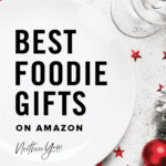 Best Foodie Gifts on Amazon Text Overlay on White Plate with Red Napkin and Wintery Christmas Table Setting Vertical Image