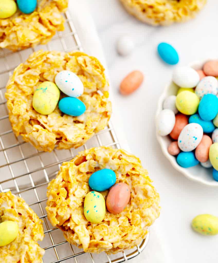Easter Treats on Wire Rack with Robin Egg Candies Around on White Marble
