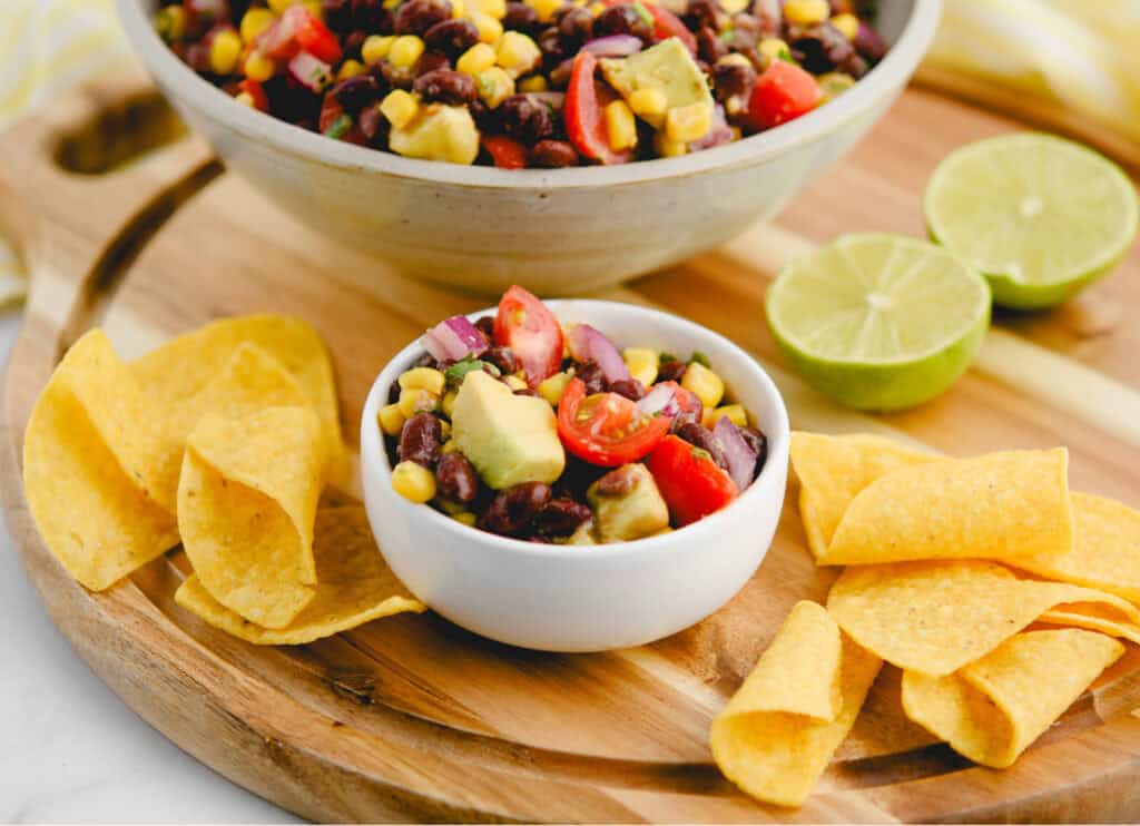 Black Bean Salad in Small Bowl with Tortilla Chips Around It