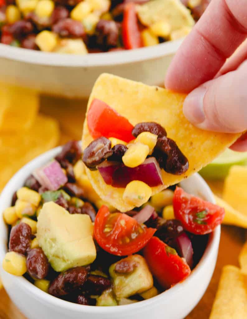 Scooping Black Bean Salad With Tortilla Chip