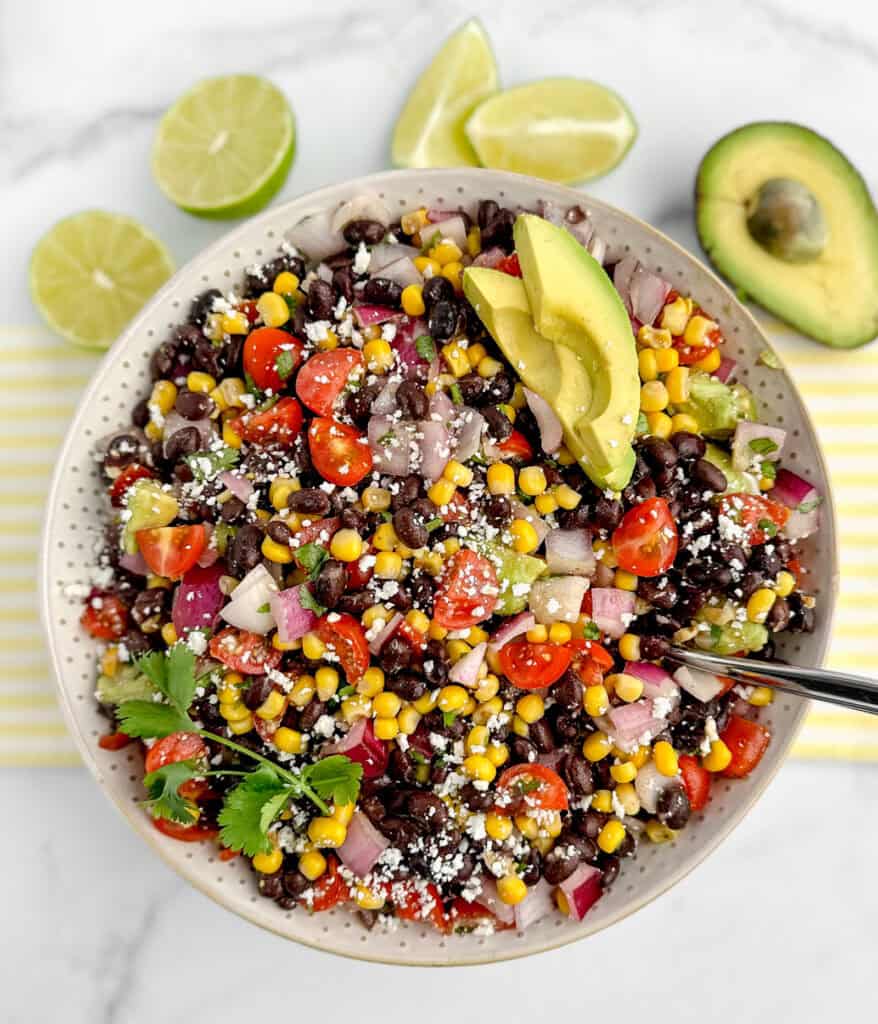 Top Down View of Black Bean Salad in White Bowl with Avocado