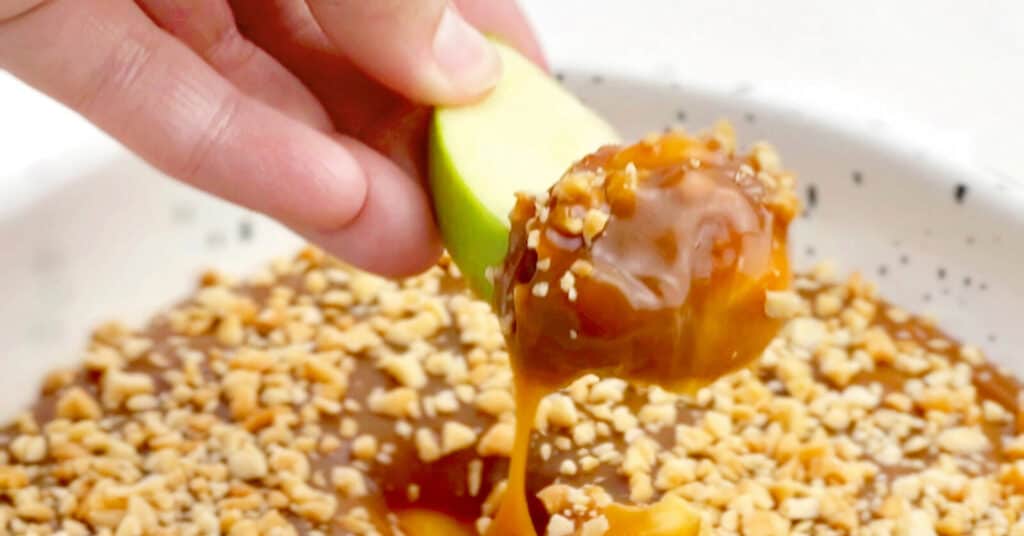 Caramel Apple Dip with Peanuts - Scooping with Green Apple 