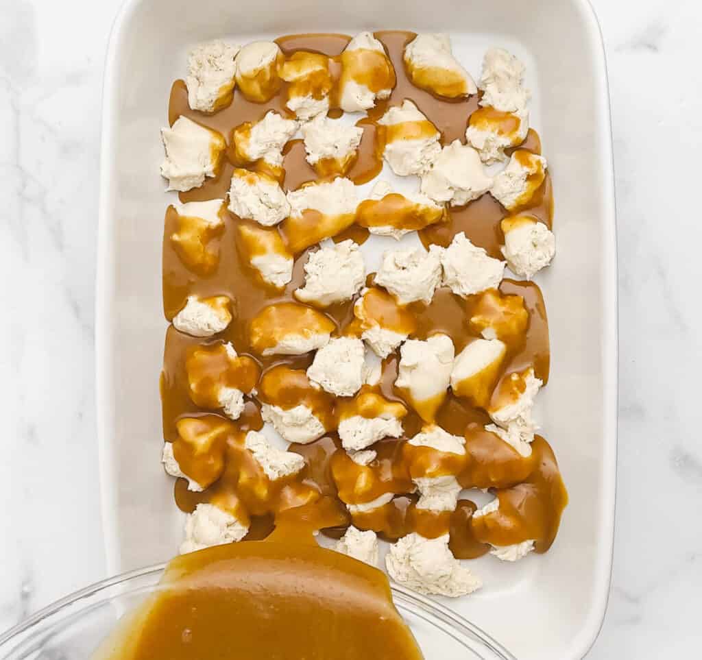Pouring Caramel Sauce Over Frozen Bread Dough in Pan