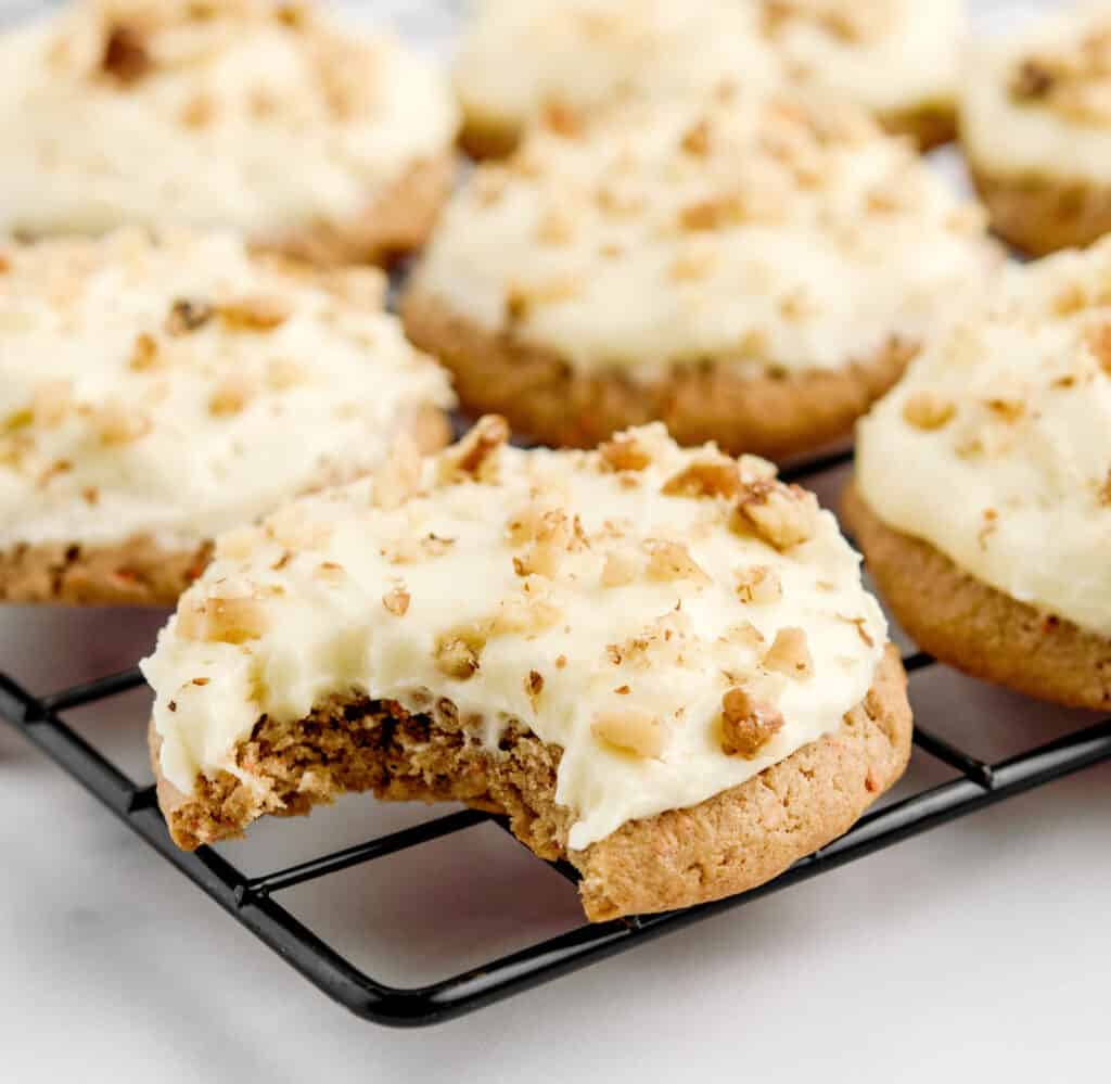 Bite Taken Out of One Cookie on Cooling Rack with More Cookies Around It