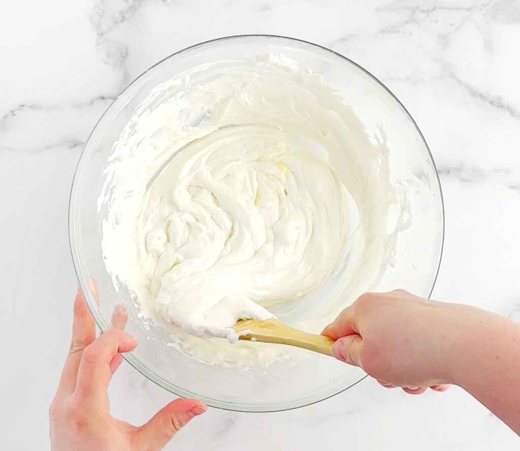 Mixing Melted Marshmallows and Butter in Glass Bowl with Wooden Spoon
