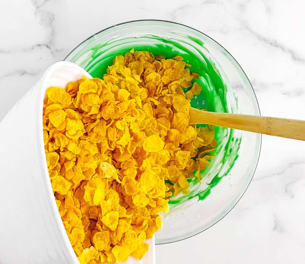 Mixing in Corn Flakes into Green Marshmallow Mixture