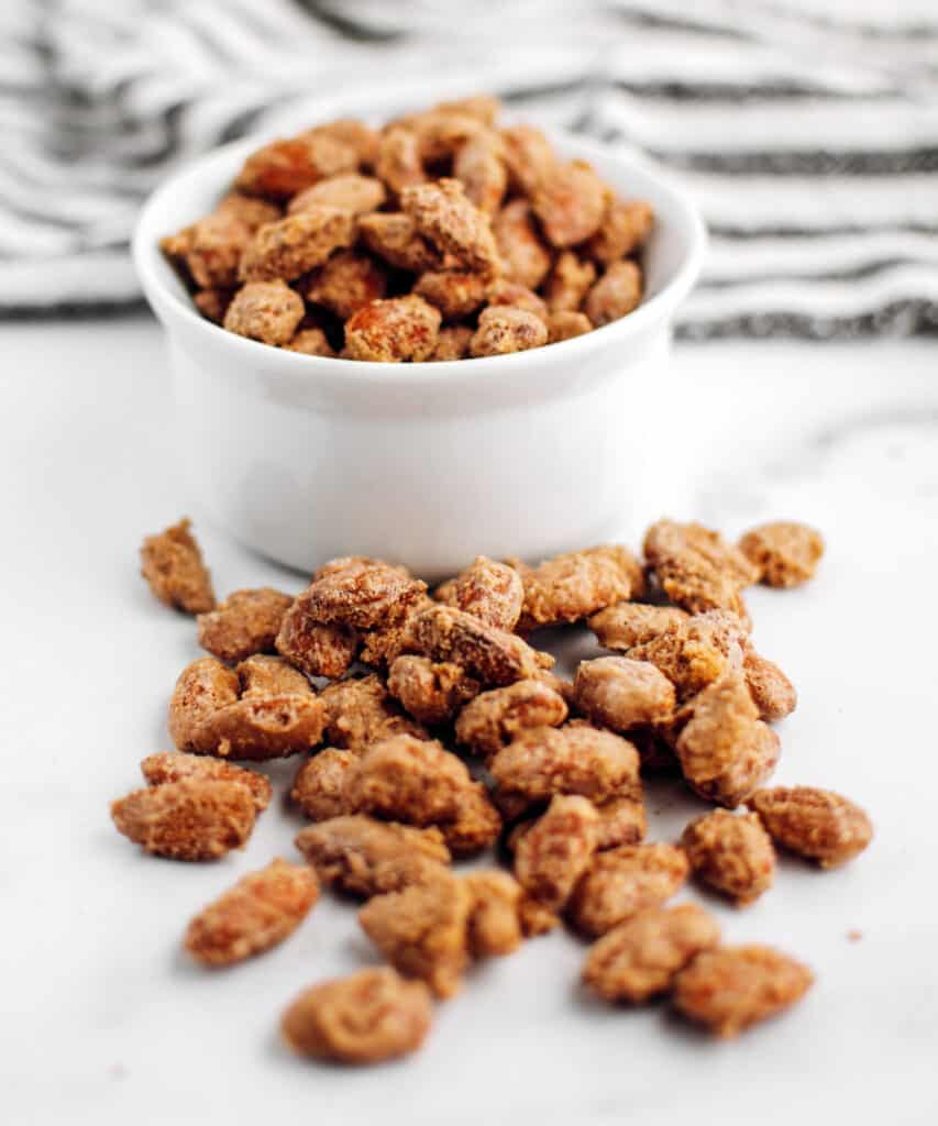 Roasted Almonds with Cinnamon Sugar in Bowl and on the Counter