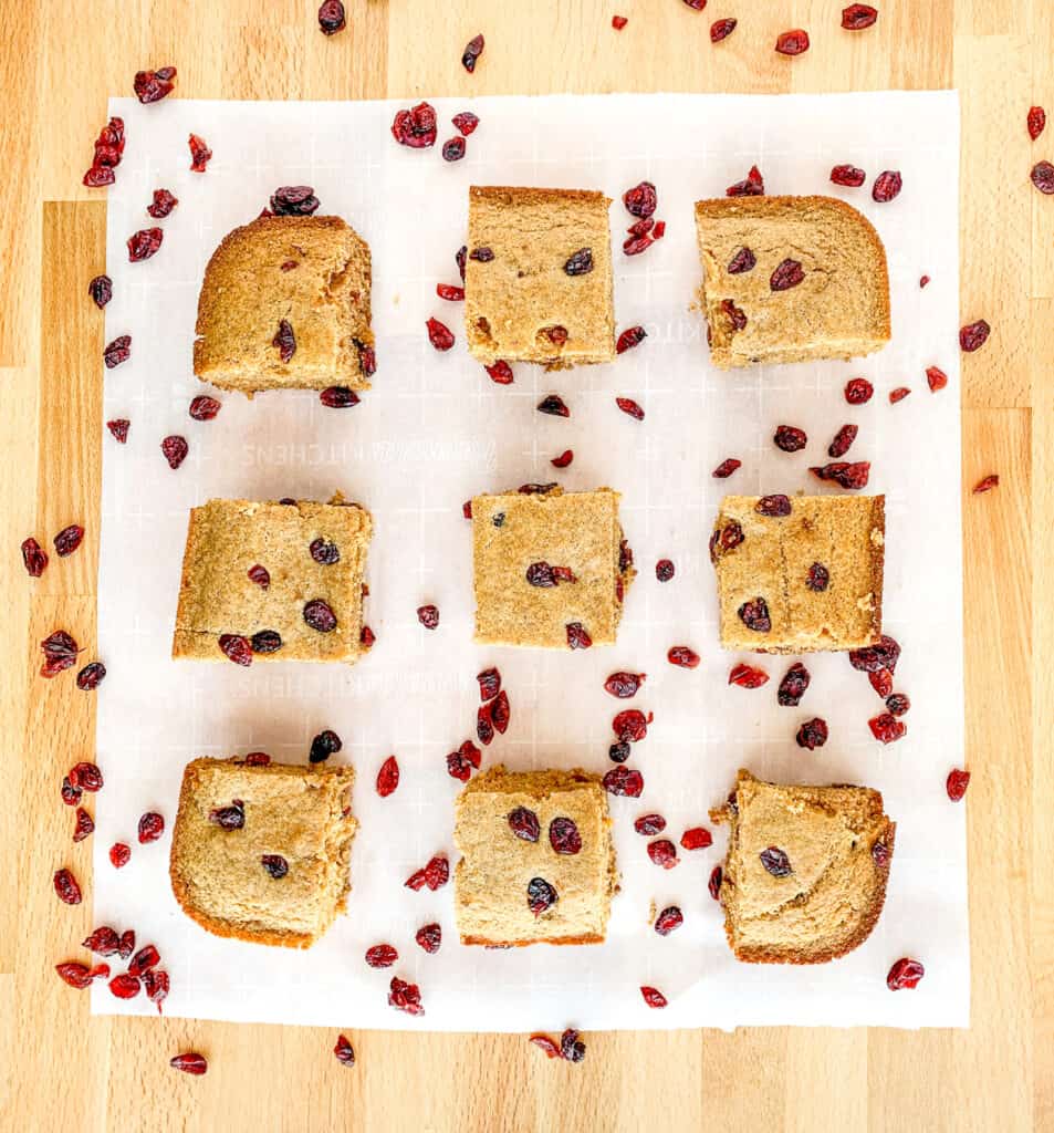Slices of Cornbread with Craisins Surrounding on Parchment Paper