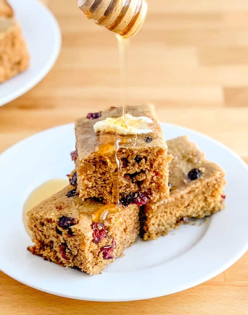 Drizzling Honey on Cinnamon Cornbread with Craisins
