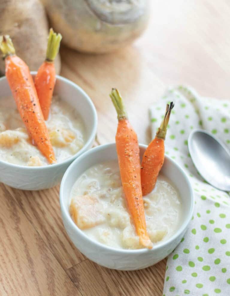 Simple Root Vegetable Soup in White Bowls with Carrots on Top