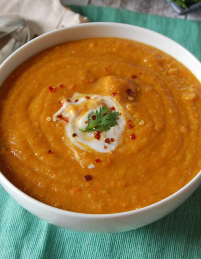 Carrot Red Lentil Soup in Bowl on Teal Tablecloth