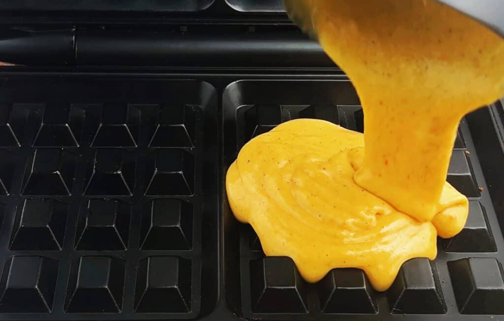 Pouring Pumpkin Waffle Batter Into Waffle Iron