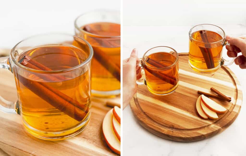 Hot Apple Cider Served in Glass Mugs with Cinnamon Sticks and Apples
