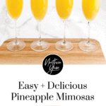 Pineapple mimosas with pineapple chunk garnishes on a tray