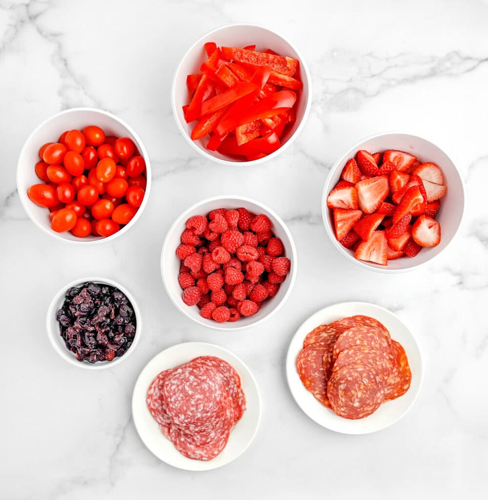 Red Ingredients in White Bowls on Marble Surface (Tomatoes, Strawberries, Peppers, Meats, etc.)