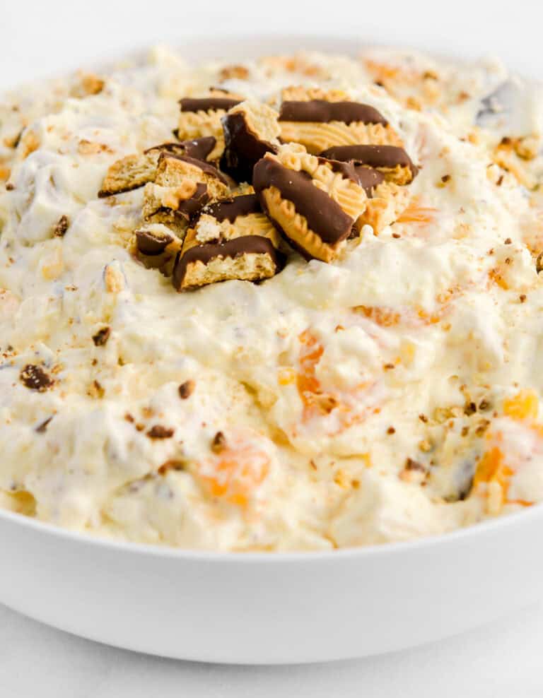Fudge Striped Cookie Salad in White Bowl with Cookie Pieces on Top