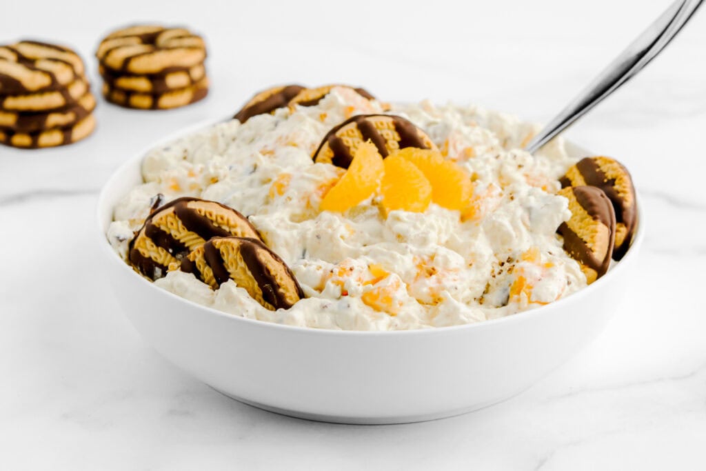 Cookie Salad Garnished with Cookies and Mandarin Oranges in Bowl with Spoon