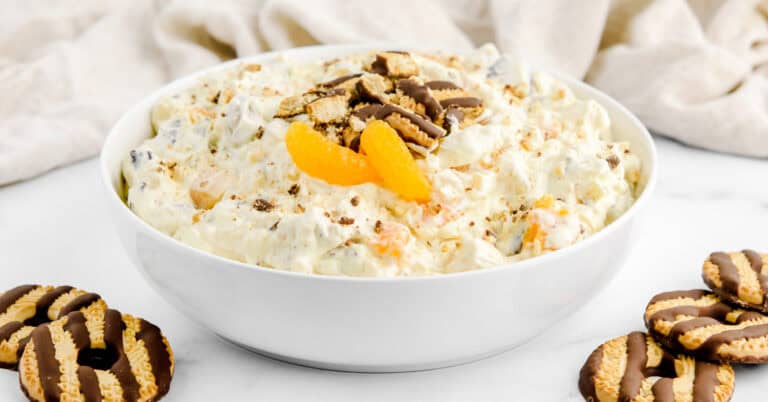 Fudge Striped Cookie Salad in White Bowl with Cookies and Mandarin Oranges on Top