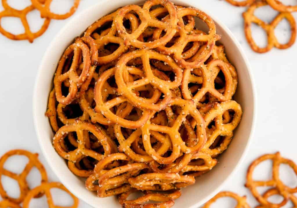 Top Down View of Bowl of Pretzels with Pretzels Around It