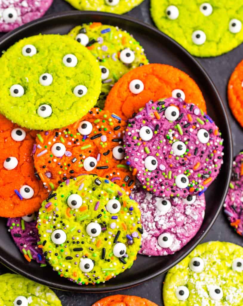 Pile of Colorful Halloween Cookies on Black Plate