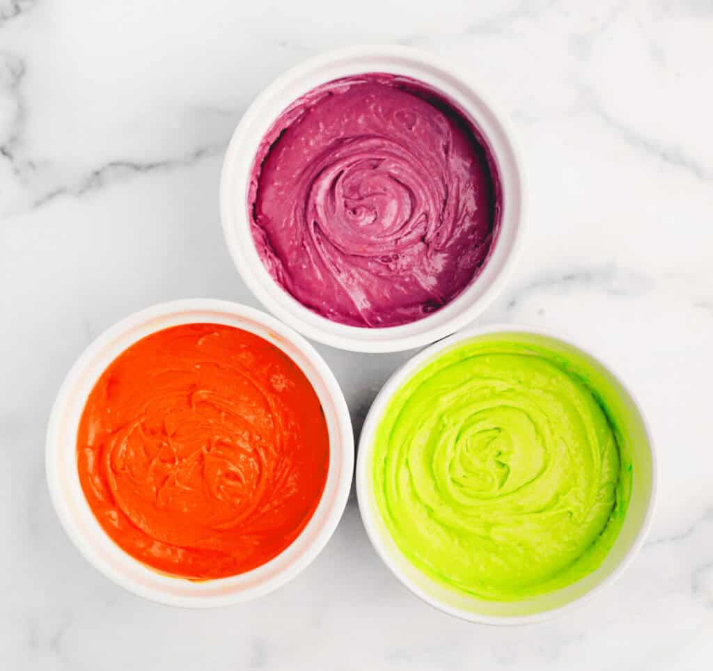 Three White Bowls with Green, Orange, and Purple Cookie Dough