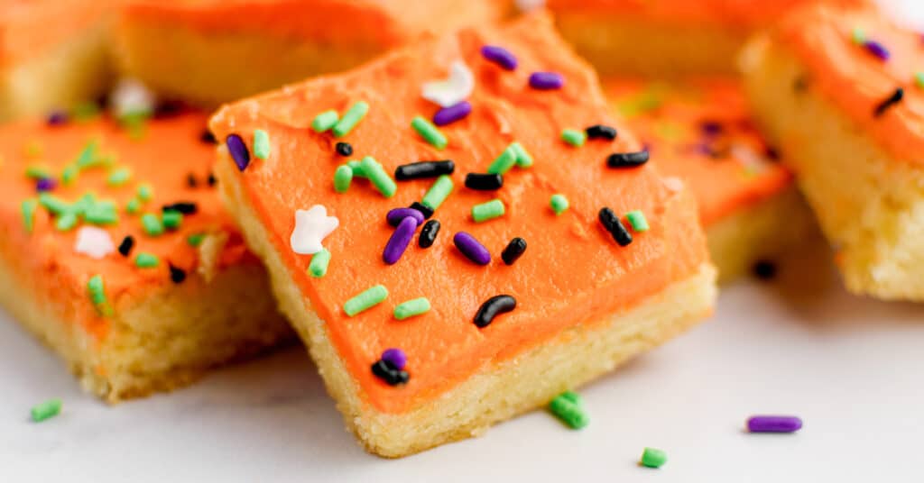 Halloween Frosted Sugar Cookie Bars Stacked on One Another