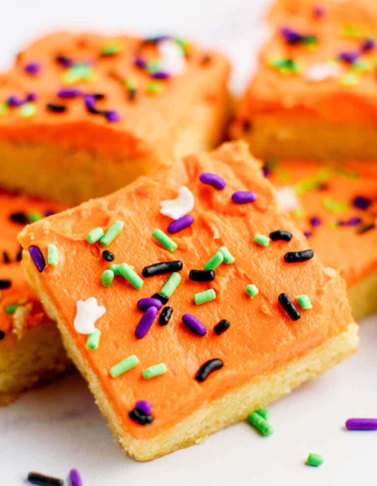 Halloween Frosted Sugar Cookie Bars Stacked on One Another