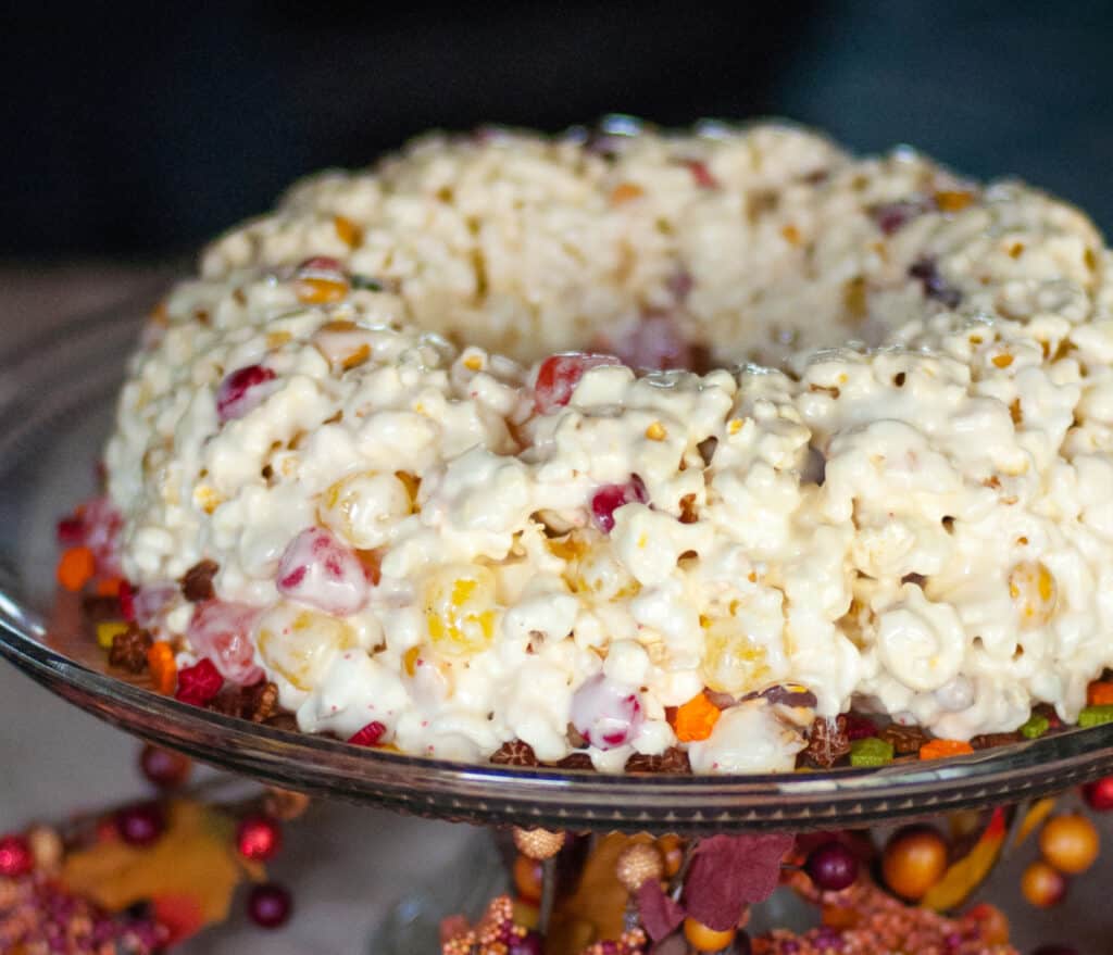 Harvest Spice Popcorn Cake on Serving Platter with Fall Decor Surrounding