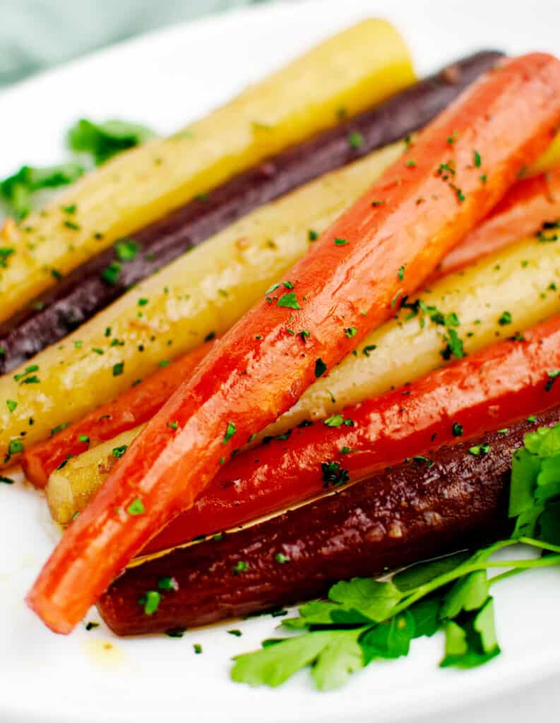 Honey Glazed Roasted Rainbow Carrots on White Platter with Parsley Closeup