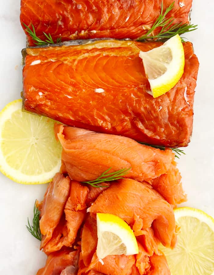 Smoked Salmon with Lemon and Herbs on White Surface
