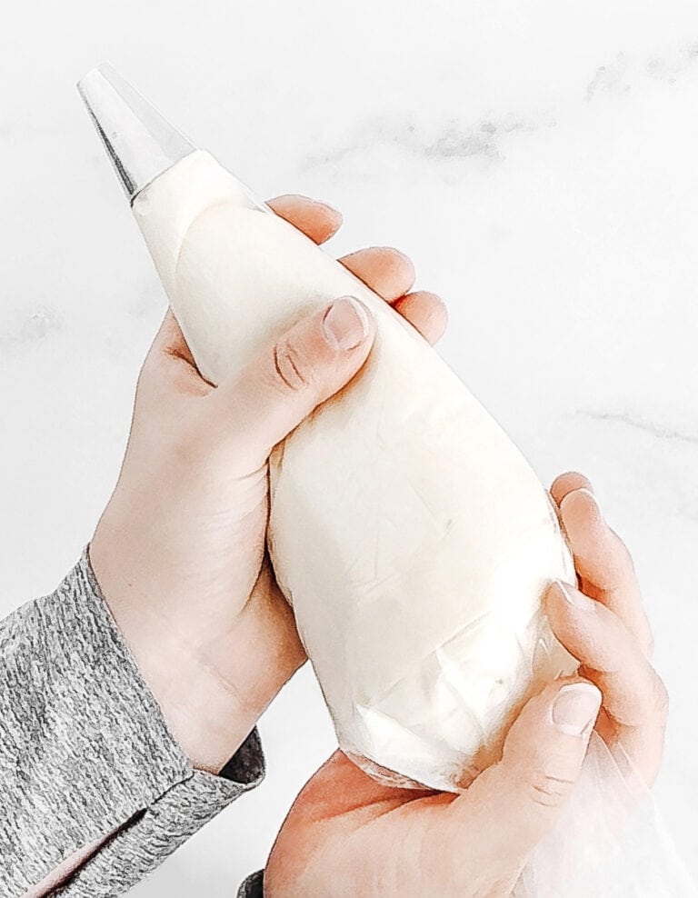 Hands Holding Piping Bag with Decorating Tip