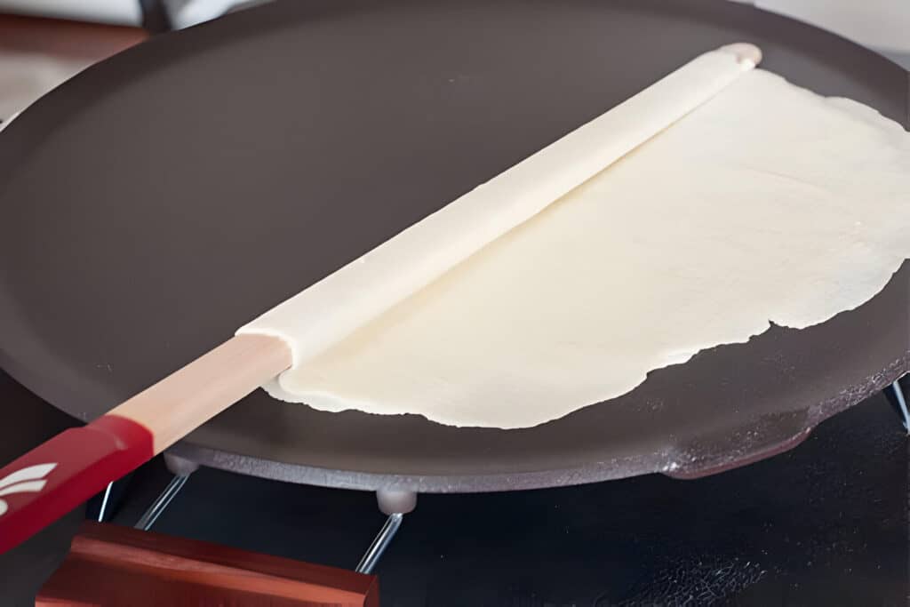Unrolling Lefse Onto Lefse Griddle