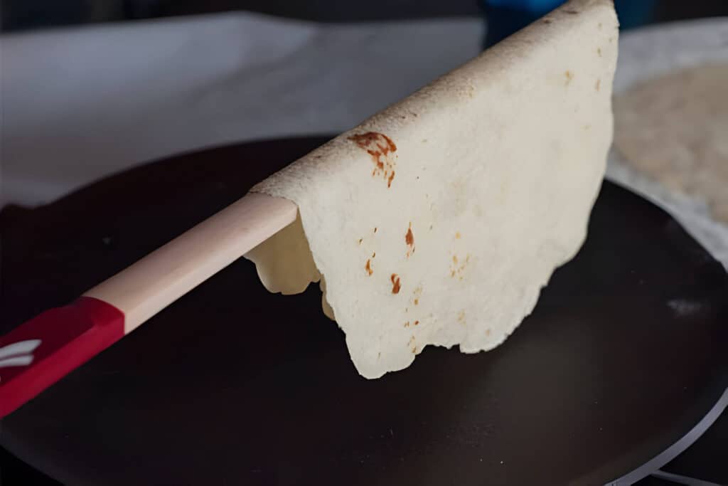 Removing Lefse from Griddle with Lefse Stick