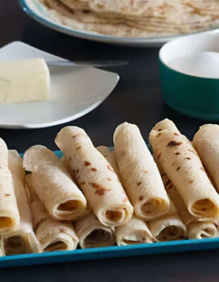 Closeup of Lefse Rolls on a Serving Platter with Butter and Sugar in the Background
