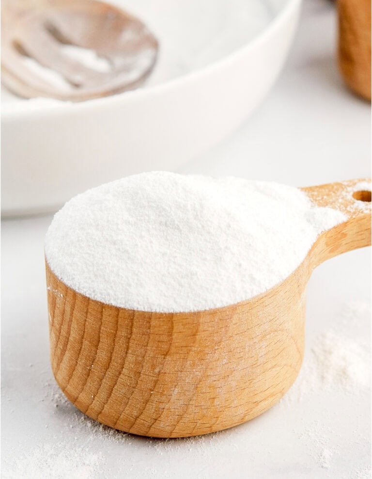 Powdered Sugar in Wooden Measuring Cup