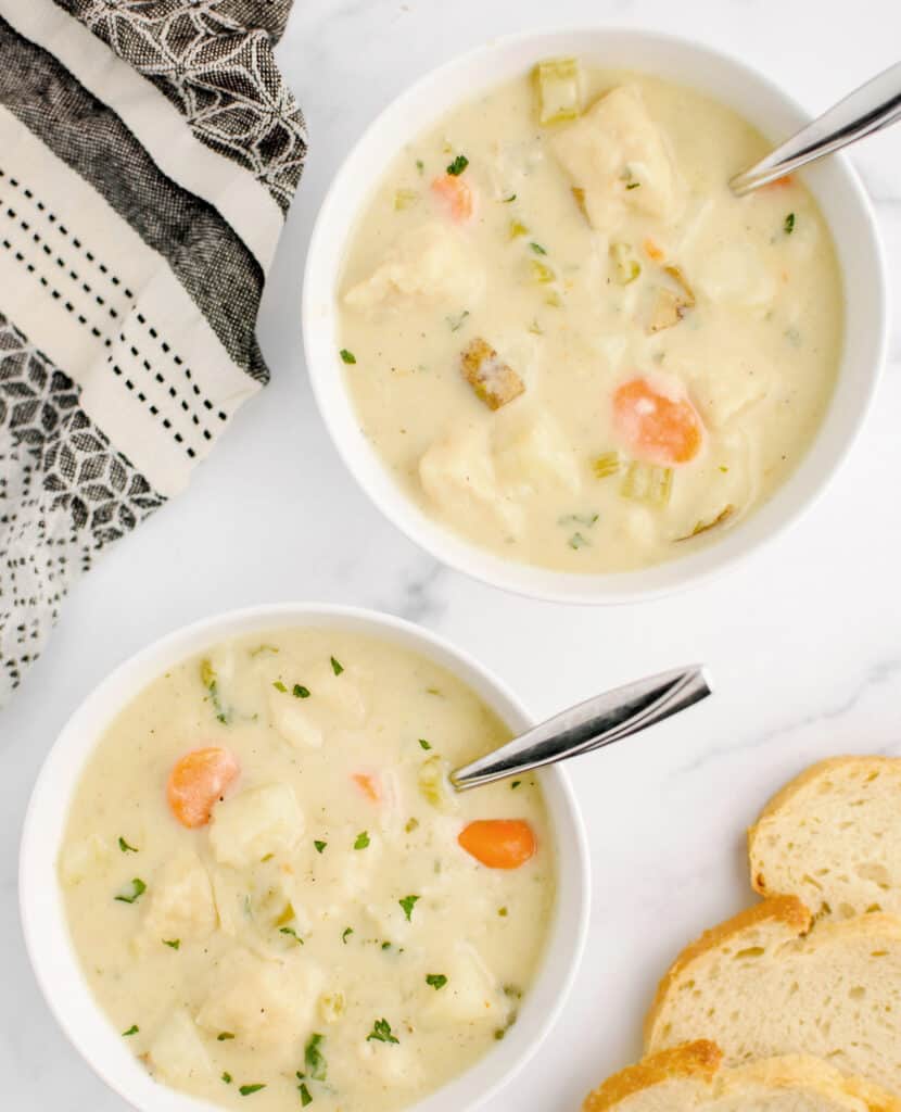 Knoephla Soup in Bowls with Bread and Kitchen Towel