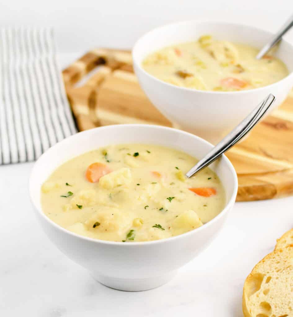 Soup in White Serving Bowls with Spoons