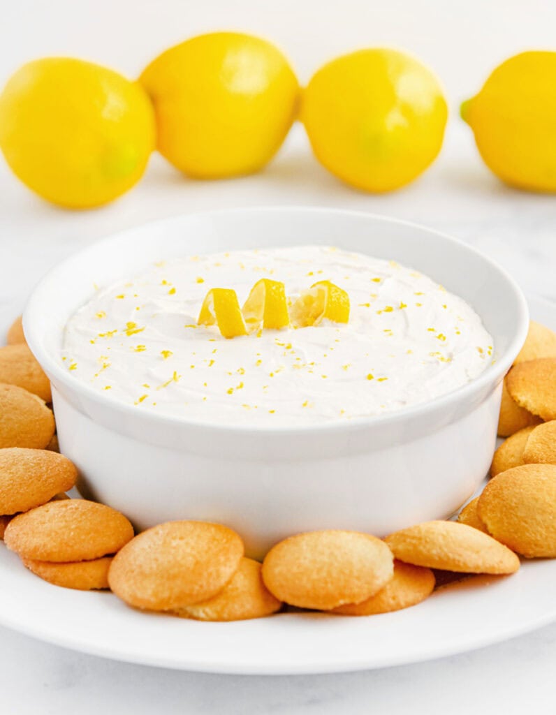 Lemon Cheesecake Dip in Bowl with Nilla Wafers Around it on a Plate