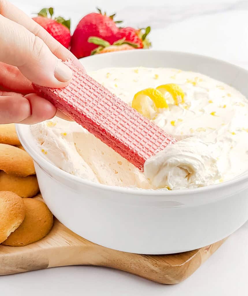 Dipping a Strawberry Wafer Into Dessert Dip