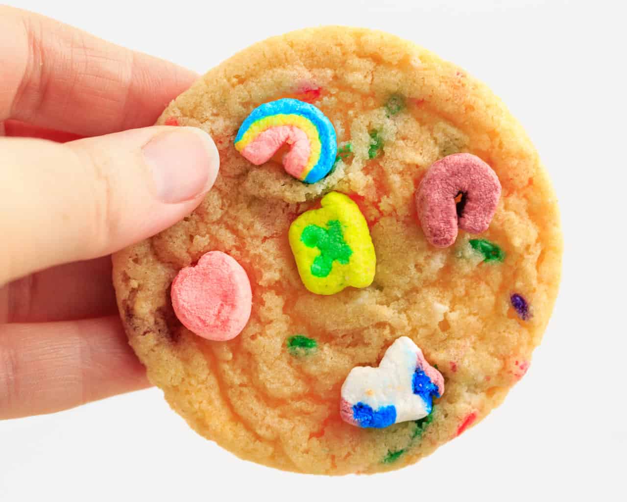 Hand Holding Cookie with Lucky Charms